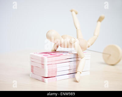 wooden dummy embracing money. Stock Photo