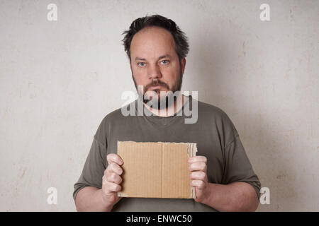 scruffy man holding sign Stock Photo