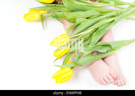 Little girl foots with flowers Stock Photo