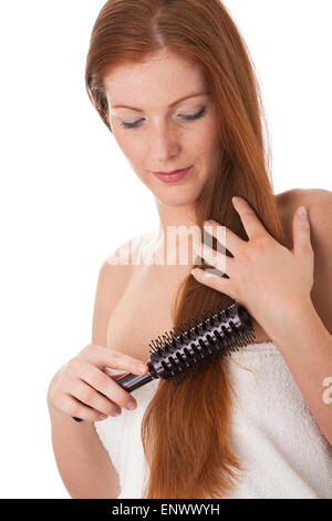 Body care series - Young woman combing her hair Stock Photo