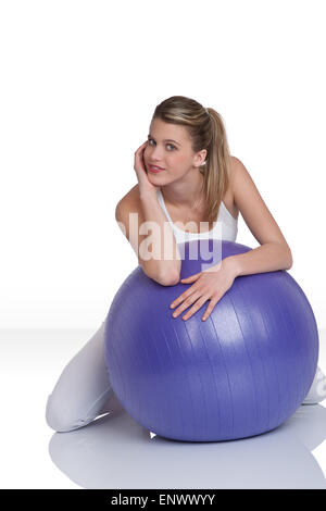 Fitness - Young woman with exercise ball on white Stock Photo
