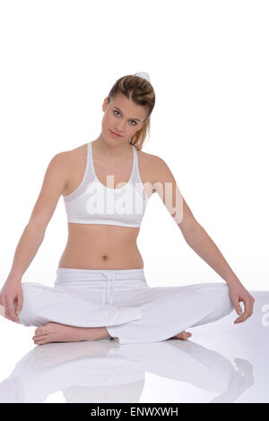 Fitness - Young woman in yoga position on white Stock Photo