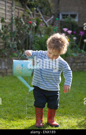 London, UK. 11th May, 2015. UK weather. Picture shows 18 month old Dexter Gilbert watering his parents garden in Southwest London, as England is on track to have unusually hot weather this Spring. Bookmakers are offering odds on this May becoming the hottest ever recorded, as a “tropical continental air mass” sweeping over the south will make parts of the UK hotter than Portugal. Credit:  Jeff Gilbert/Alamy Live News Stock Photo