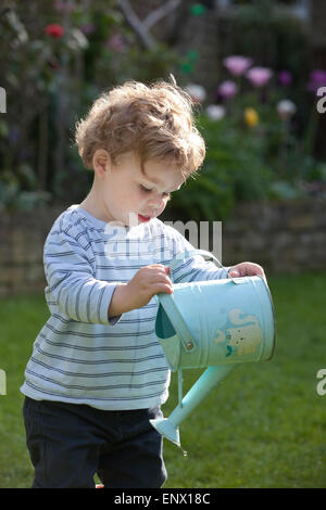 London, UK. 11th May, 2015. UK weather. Picture shows 18 month old Dexter Gilbert watering his parents garden in Southwest London, as England is on track to have unusually hot weather this Spring. Bookmakers are offering odds on this May becoming the hottest ever recorded, as a “tropical continental air mass” sweeping over the south will make parts of the UK hotter than Portugal. Credit:  Jeff Gilbert/Alamy Live News Stock Photo