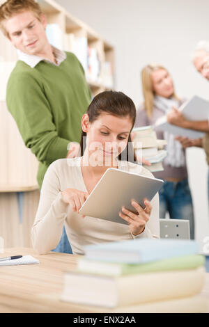 Touch screen tablet computer - students in library Stock Photo