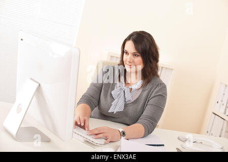 Young attractive business woman working at office Stock Photo