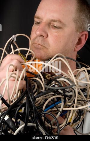 Man Tangled in Wires Stock Photo