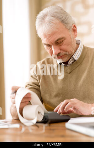 Senior mature man - home office with calculator Stock Photo