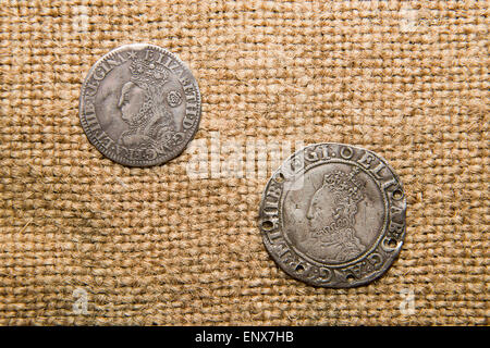 A lot of old England  silver coins with portraits of kings on the old cloth Stock Photo