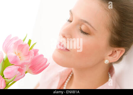 Fashion - young romantic woman smell spring tulips Stock Photo