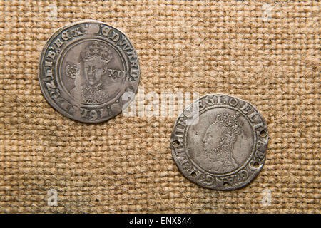 A lot of old England  silver coins with portraits of kings on the old cloth Stock Photo