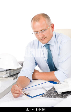 Professional architect with blueprint behind table Stock Photo
