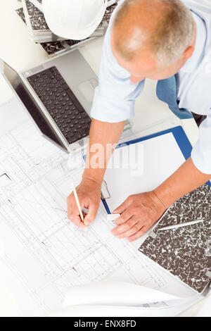 Senior man work on blueprints construction plans Stock Photo