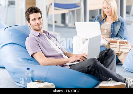 Young students at high-school working on laptop Stock Photo