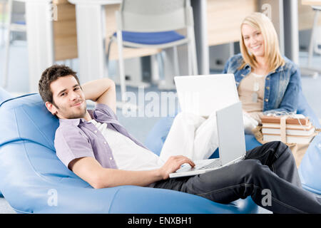 Young students at high-school relax with laptop Stock Photo