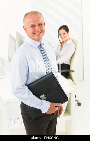 Professional senior businessman hold briefcase in Stock Photo