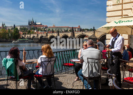 Prague cafe view People Tourists Prague panorama Prague Castle Charles Bridge Vltava river Czech Republic Landmark Stock Photo