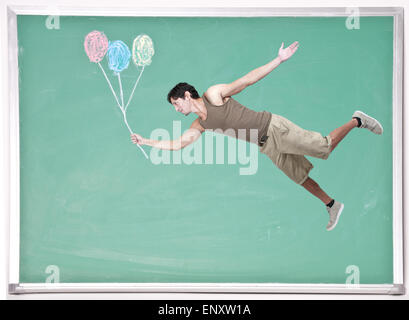 Man Floating with Chalk Balloons Stock Photo