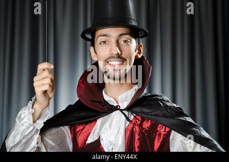 Magician doing tricks on white Stock Photo