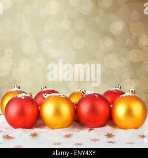 Snowy Christmas balls and gold stars on the abstract background with bokeh effect Stock Photo