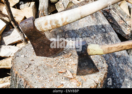 two axes in block for chopping firewood close up Stock Photo