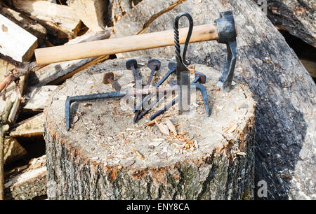 hew ax and forged hardware on wooden deck near village smithy Stock Photo