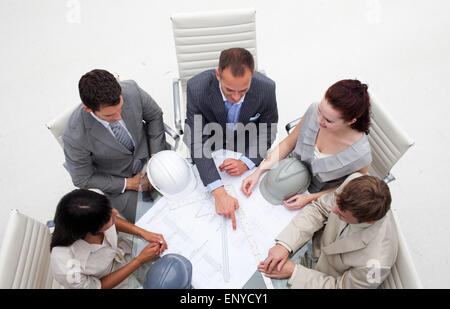 High angle of architects working with blueprints Stock Photo