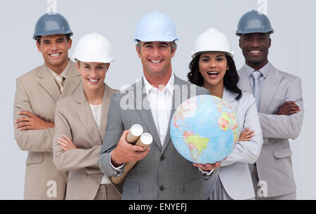 Enginner team holding a terrestrial globe Stock Photo