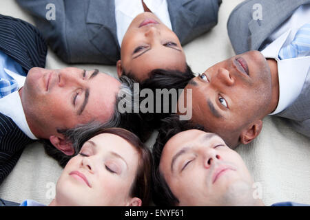 Close-up of relaxed business team lying in circle Stock Photo