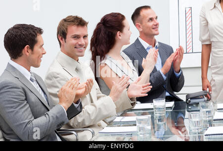 Business people applauding a colleague after giving a presentation Stock Photo