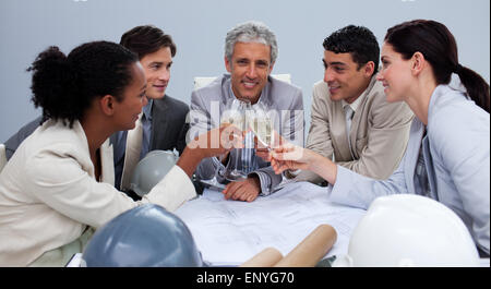 Happy architectutal team having a celebration with champagne Stock Photo