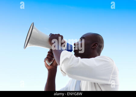 African businessman shouting in a megaphone Stock Photo