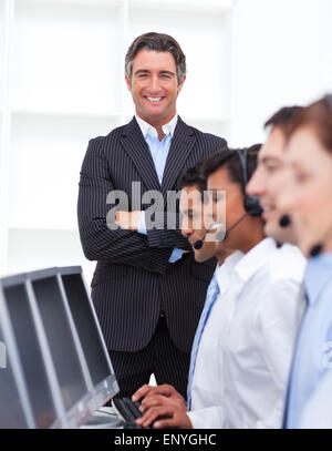 Self-assured businessman presenting a call center Stock Photo