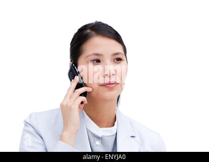 Portrait of a concentrated businesswoman on phone isolated in a white background Stock Photo