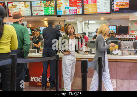 Customers on line at a busy Wendy's fast food restaurant in New York on Wednesday, May 6, 2015. Wendy's announced that it will sell 640 company owned stores to franchisees. The sales, which McDonald's is doing also, generates cash and reduces expenses for the company. (© Richard B. Levine) Stock Photo