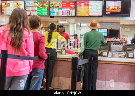 Customers on line at a busy Wendy's fast food restaurant in New York on Wednesday, May 6, 2015. Wendy's announced that it will sell 640 company owned stores to franchisees. The sales, which McDonald's is doing also, generates cash and reduces expenses for the company. (© Richard B. Levine) Stock Photo