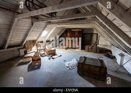 Old attic with hidden secrets of an abandoned house Stock Photo