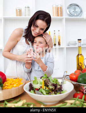 Litlle girl and her mother preparing a salad Stock Photo
