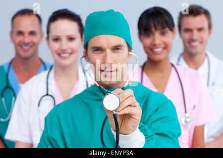 Charismatic surgeon and his medical team Stock Photo