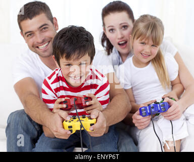 Family playing video games at home Stock Photo