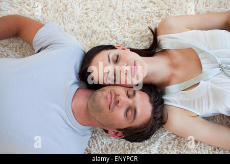Couple sleeping on the floor Stock Photo