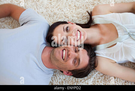 Smiling Couple lying on the floor Stock Photo