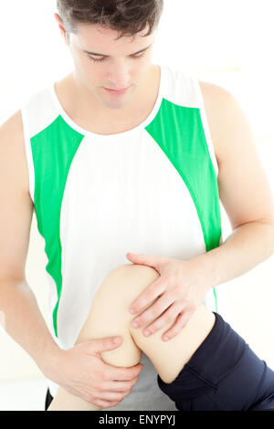 Attractive physical therapist checking a woman's knee Stock Photo