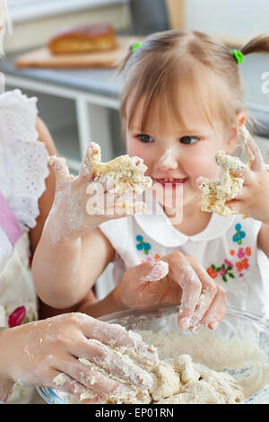 Woman baking cookies with her daughter Stock Photo