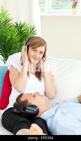 Charming caucasian couple listen to music wearing headphones Stock Photo