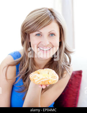 Joyful woman holding a danish pastry Stock Photo