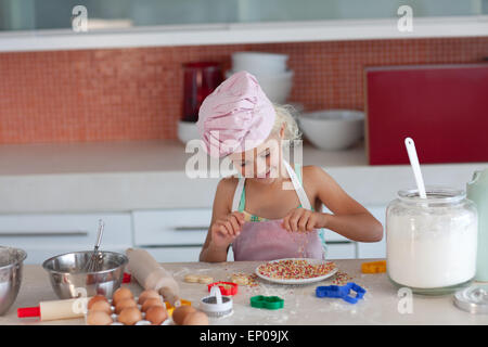 Blond girl baking biscuits for her family Stock Photo