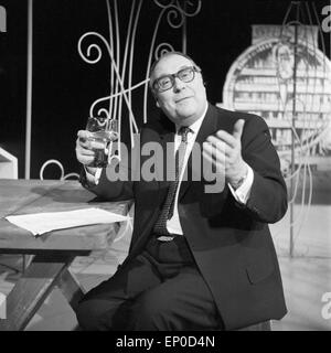 Deutscher Komiker und Wortspieler Heinz Erhardt mit einem Glas Wein, Anfang 1960er Jahre. German comedian and master of pun, Stock Photo