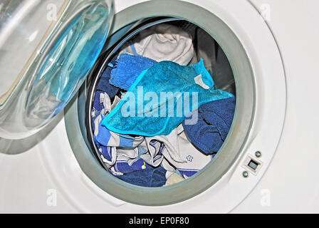 close up of a washing machine with open door and dirty linen, detail, full frame, horizontal, tilt, slanted Stock Photo