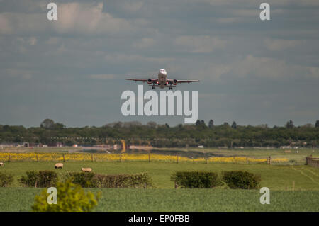 London Gatwick Airport, Surrey, UK. 12th May, 2015. Weather: Easy Jet Airbus A320 takes off over the countryside. Credit:  David Burr/Alamy Live News Stock Photo